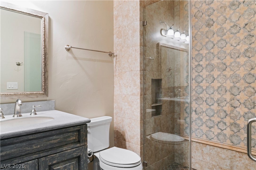 1123 Christian Road Henderson, NV 89002 - Photo 33 of 94 A well-appointed bathroom features a glass-enclosed shower and an elegant vanity with a marble countertop.