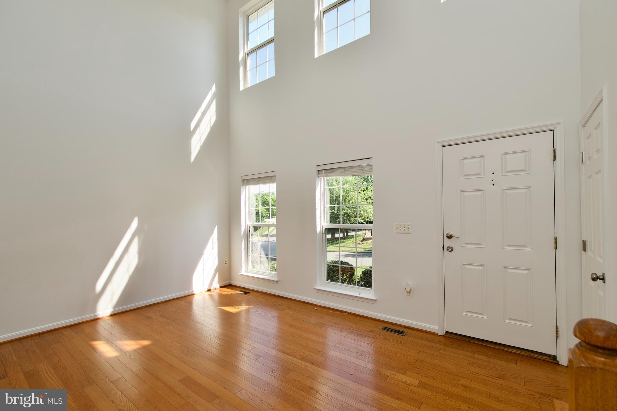 17528 October Glory Loop Dumfries, VA 22026 - Photo 3 of 50 an empty room with wooden floor and windows