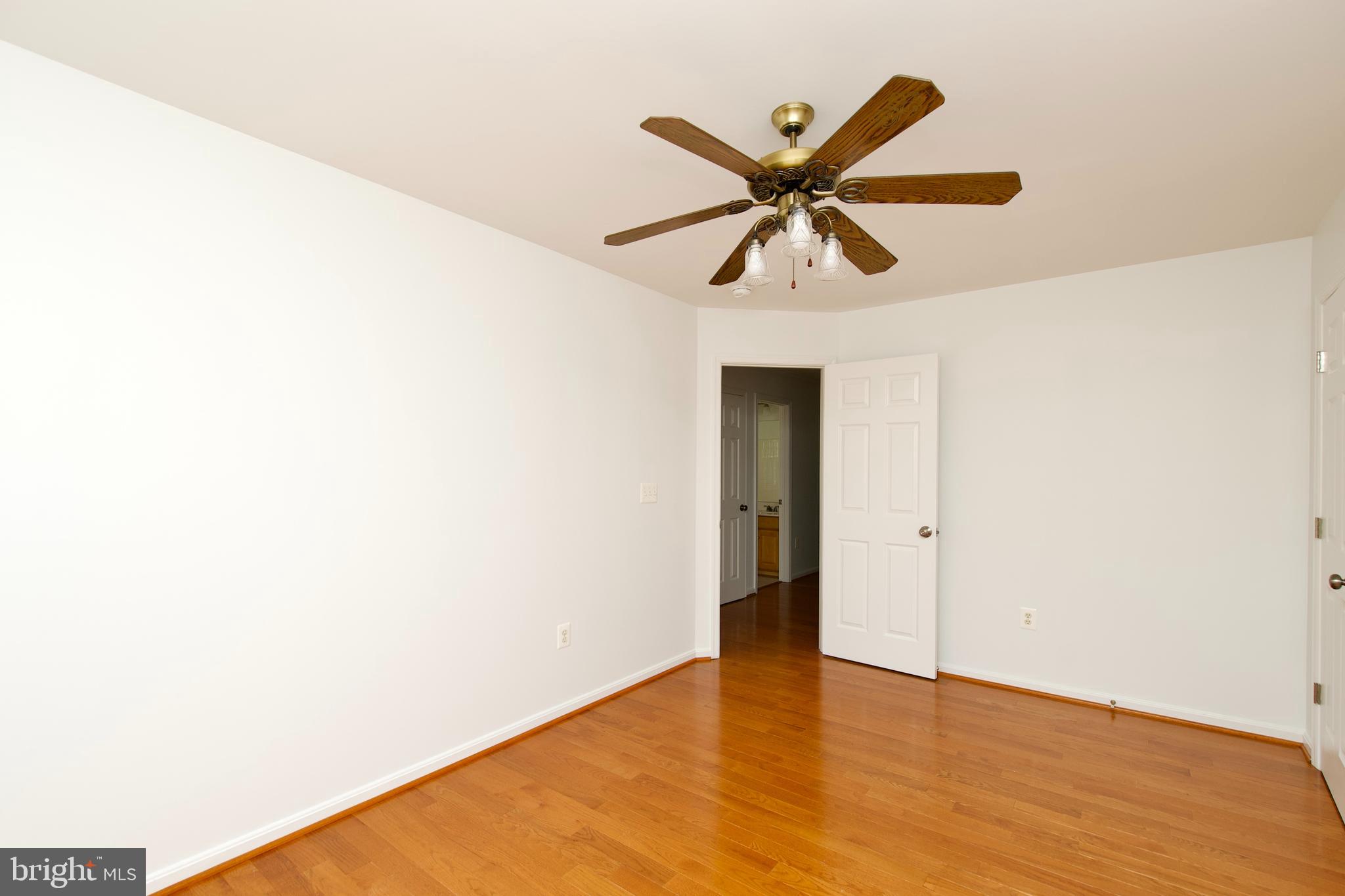 17528 October Glory Loop Dumfries, VA 22026 - Photo 36 of 50 a view of a room with a ceiling fan and wooden floor