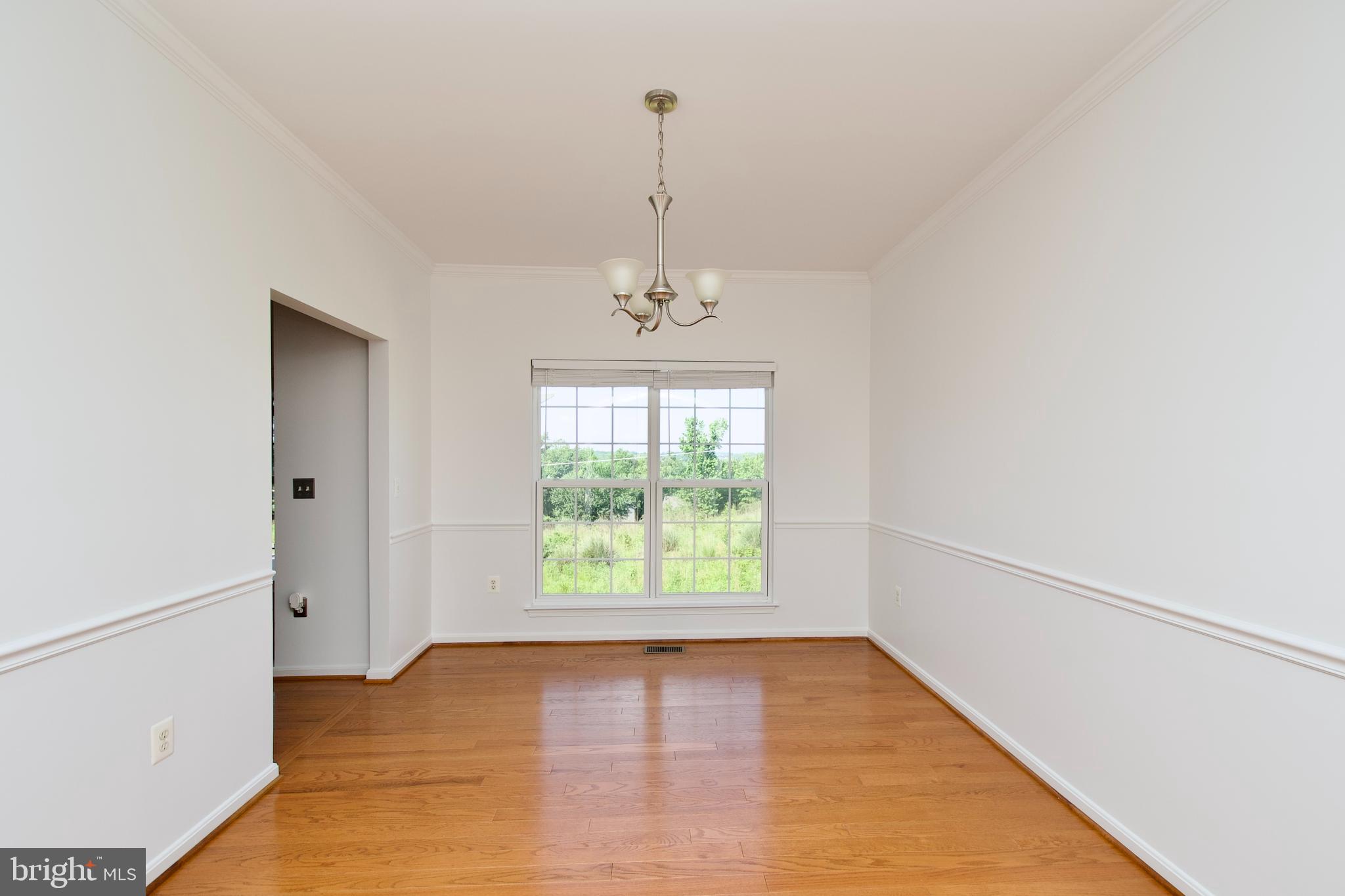 17528 October Glory Loop Dumfries, VA 22026 - Photo 8 of 50 wooden floor in an empty room with a window