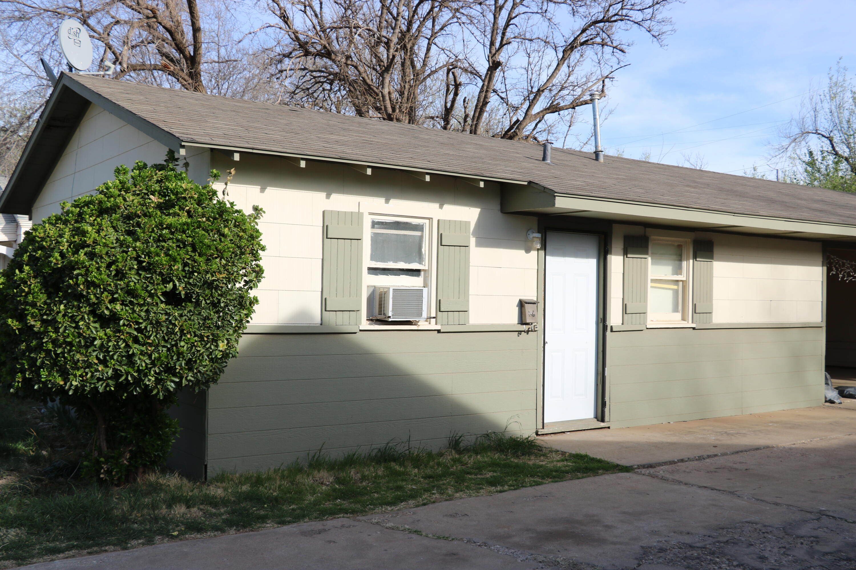 2429 23rd Street, Unit B Lubbock, TX 79411 - Photo 1 of 1 a front view of a house with garden