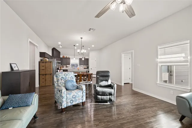 a kitchen with refrigerator a sink and chairs