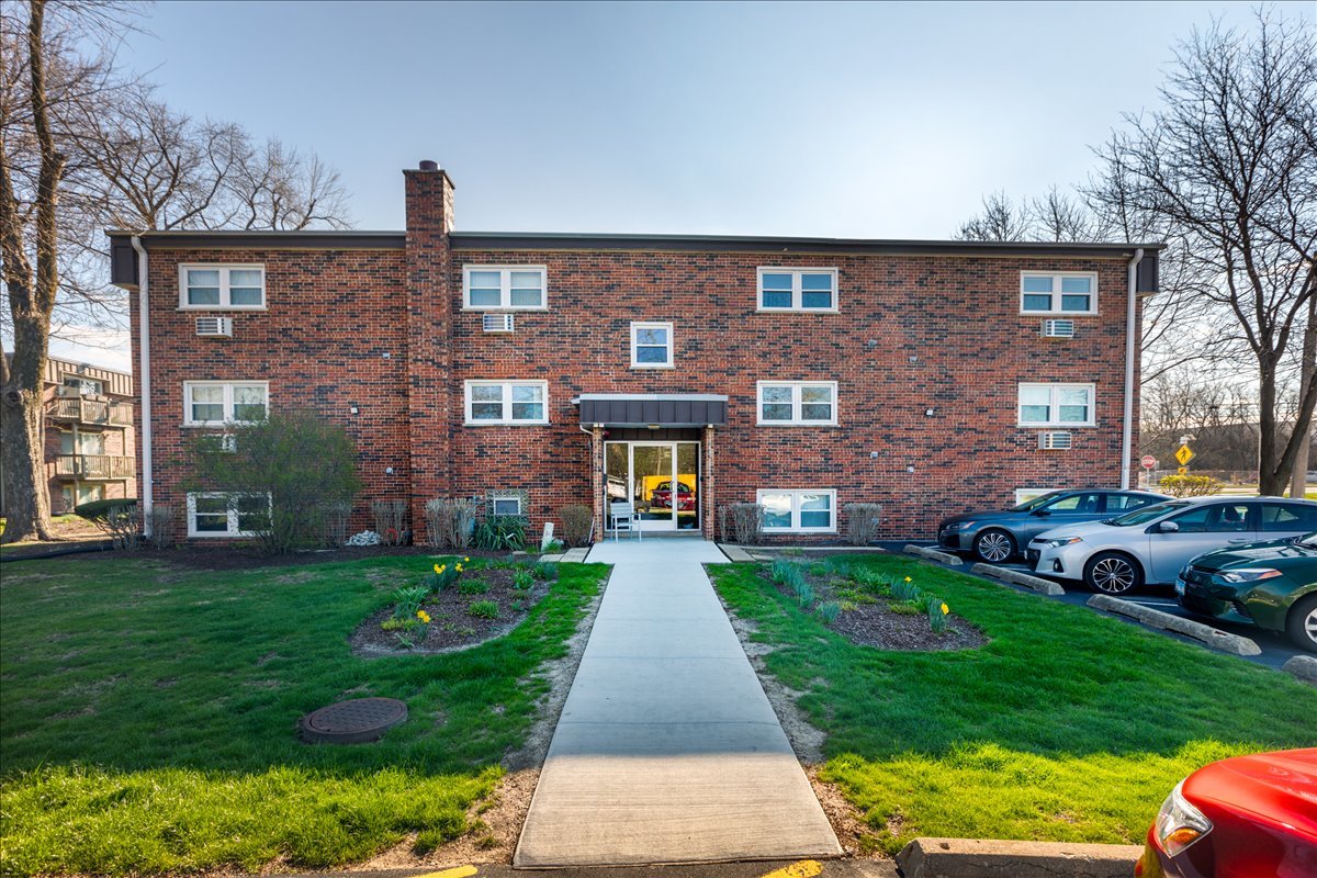 5740 East Avenue, Unit 2D Countryside, IL 60525 - Photo 1 of 24 a front view of a brick house with a yard