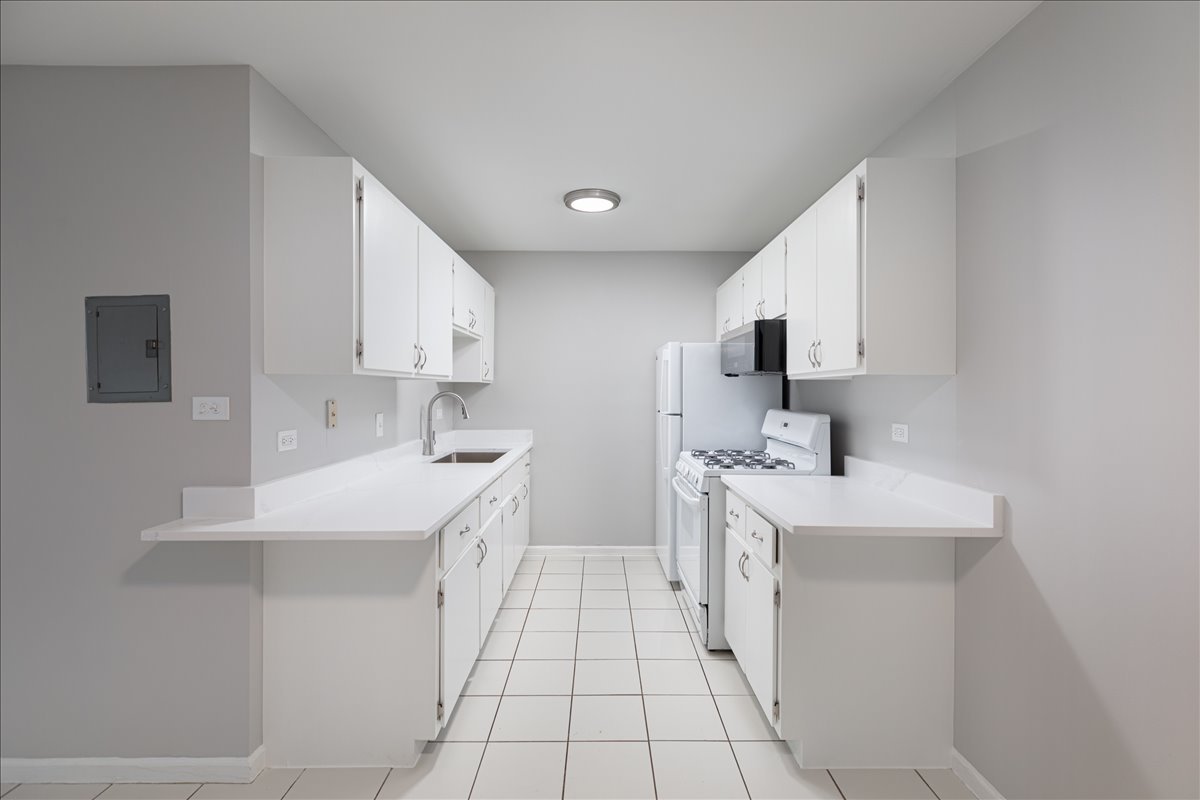 5740 East Avenue, Unit 2D Countryside, IL 60525 - Photo 2 of 24 a kitchen with a sink stove and cabinets