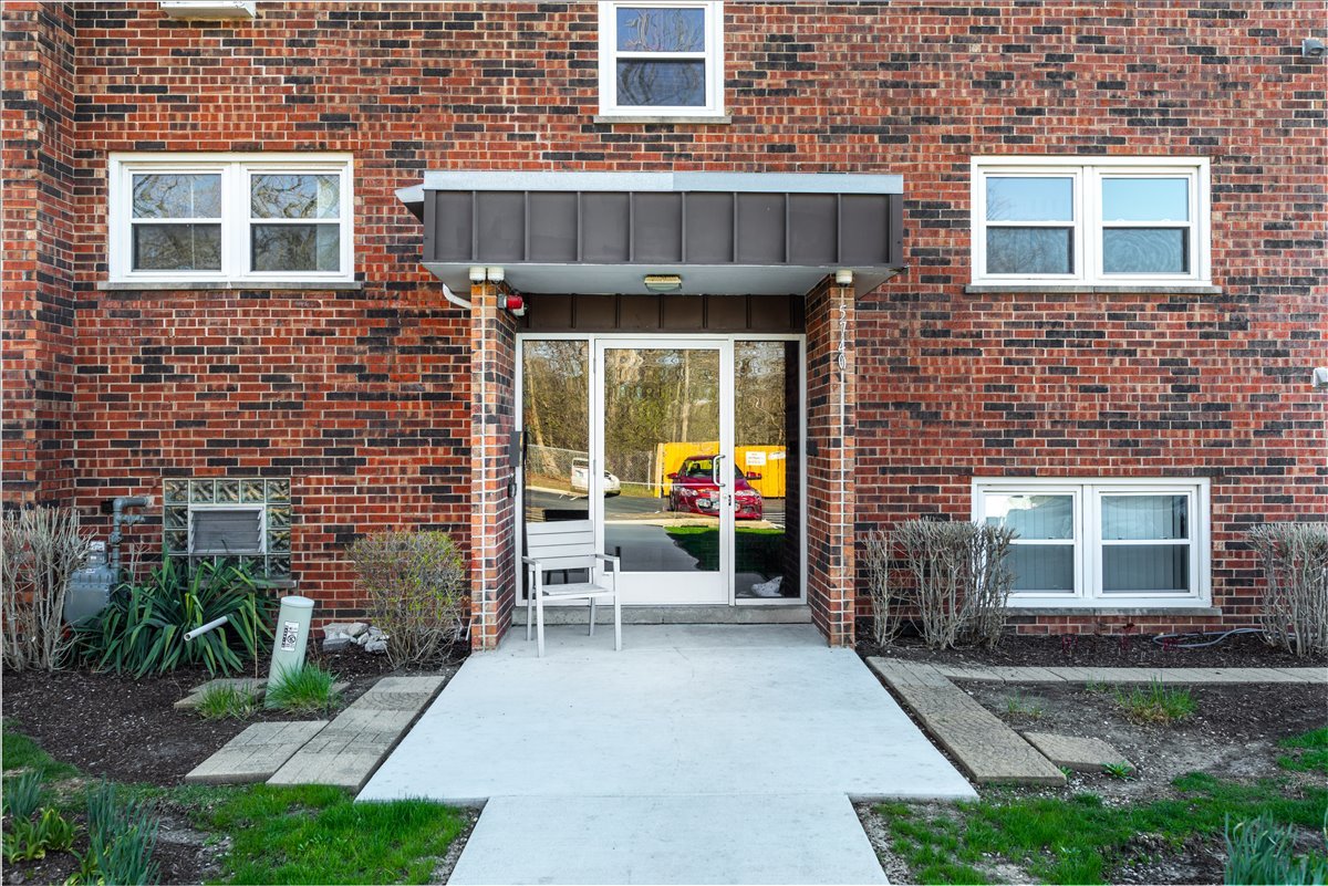 5740 East Avenue, Unit 2D Countryside, IL 60525 - Photo 24 of 24 a view of a brick building with a bench in front of house