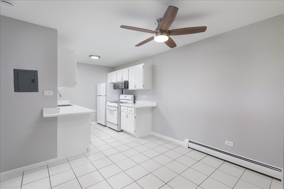 5740 East Avenue, Unit 2D Countryside, IL 60525 - Photo 6 of 24 a kitchen with white cabinets and sink