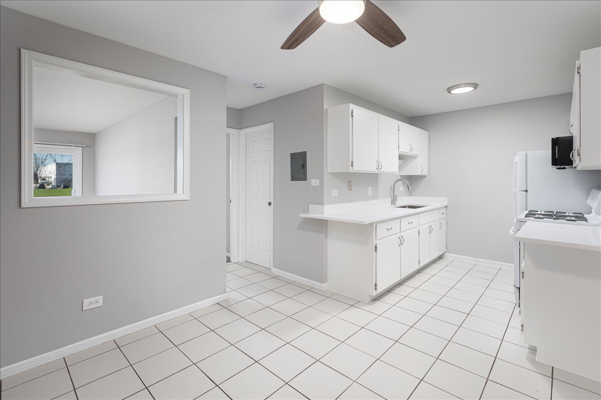 5740 East Avenue, Unit 2D Countryside, IL 60525 - Photo 7 of 24 a kitchen with a sink cabinets and window