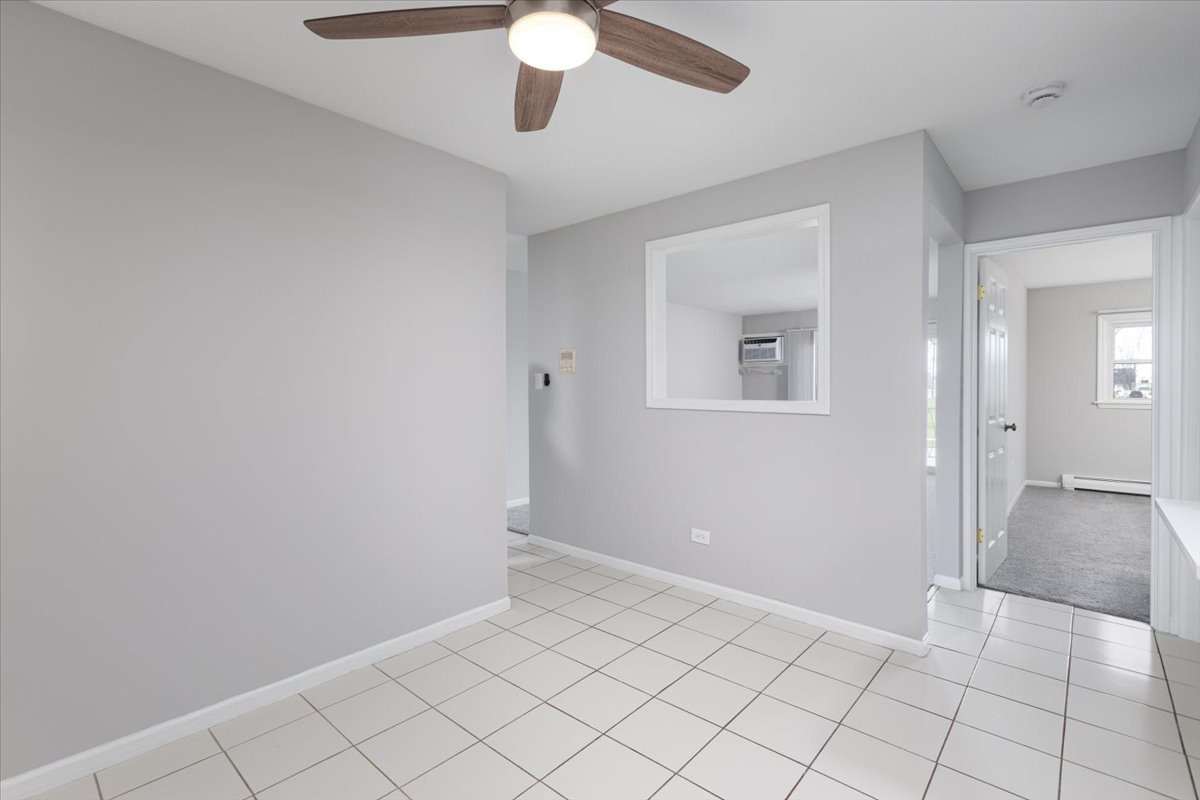 5740 East Avenue, Unit 2D Countryside, IL 60525 - Photo 8 of 24 wooden floor in an empty room with a window