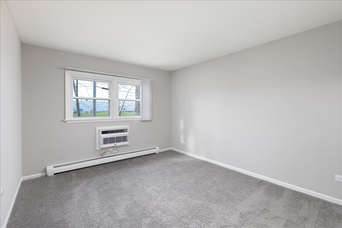 5740 East Avenue, Unit 2D Countryside, IL 60525 - Photo 9 of 24 an empty room with a window
