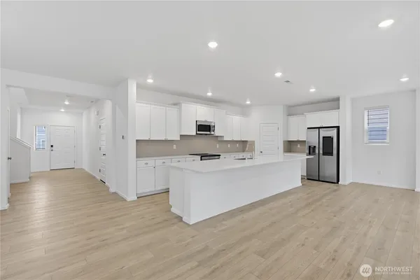 a kitchen with stainless steel appliances a sink stove and cabinets