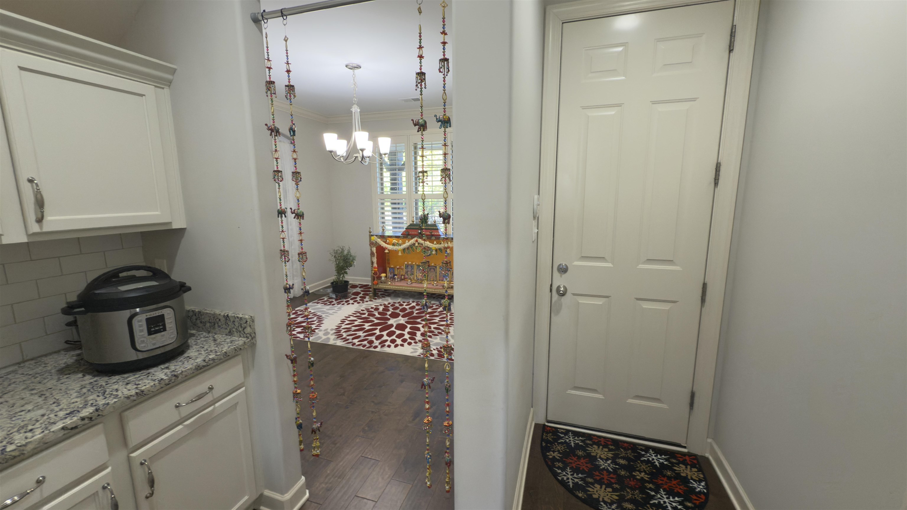 1217 Pilgrim Ridge Road Collierville, TN 38017 - Photo 18 of 33 Doorway to outside with a chandelier, wood finished floors, and ornamental molding