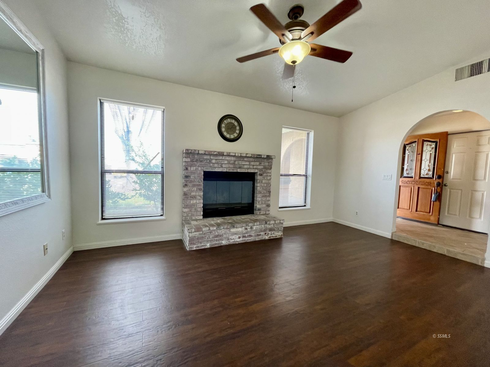 225 Michele Street Ridgecrest, CA 93555 - Photo 12 of 36 a view of an empty room with wooden floor fireplace and a window