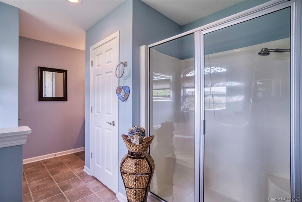 126 Barkers Grove Road Union Grove, NC 28689 - Photo 14 of 48 a bathroom with a glass shower door and a window
