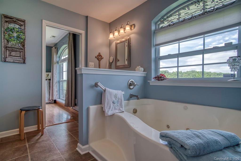 126 Barkers Grove Road Union Grove, NC 28689 - Photo 15 of 48 a bathroom with a bathtub and a window