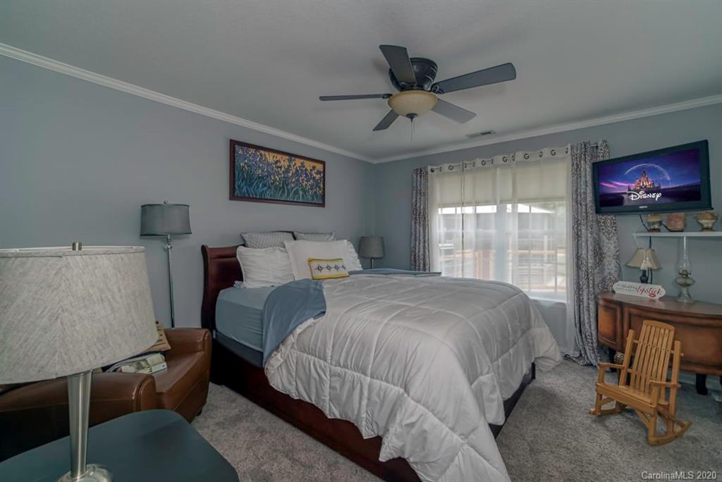 126 Barkers Grove Road Union Grove, NC 28689 - Photo 16 of 48 a bedroom with a bed a couch and a window