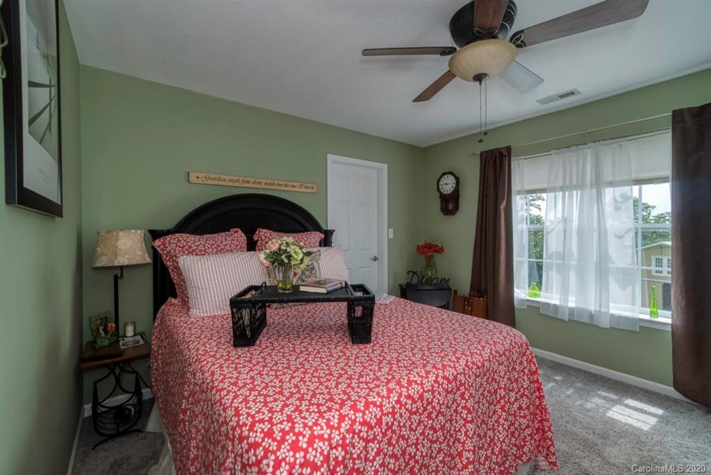 126 Barkers Grove Road Union Grove, NC 28689 - Photo 18 of 48 a bedroom with a bed a large window with table and chairs