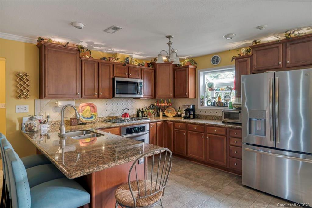 126 Barkers Grove Road Union Grove, NC 28689 - Photo 9 of 48 a kitchen with stainless steel appliances granite countertop a sink refrigerator and microwave