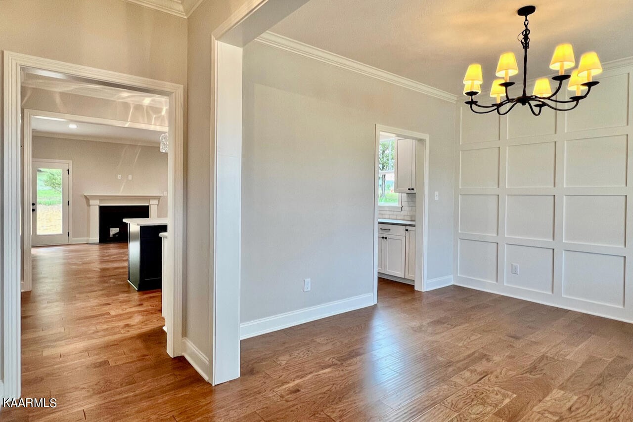 9356 Gabrielle Road Strawberry Plains, TN 37871 - Photo 6 of 39 a view of a hallway with wooden floor and a chandelier