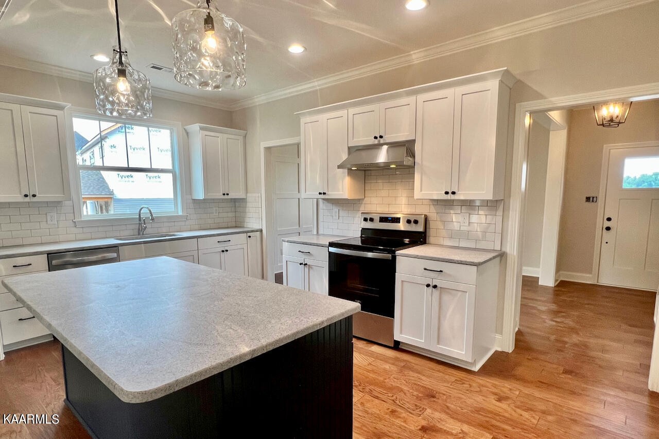 9356 Gabrielle Road Strawberry Plains, TN 37871 - Photo 8 of 39 a kitchen with stainless steel appliances granite countertop a sink stove and refrigerator
