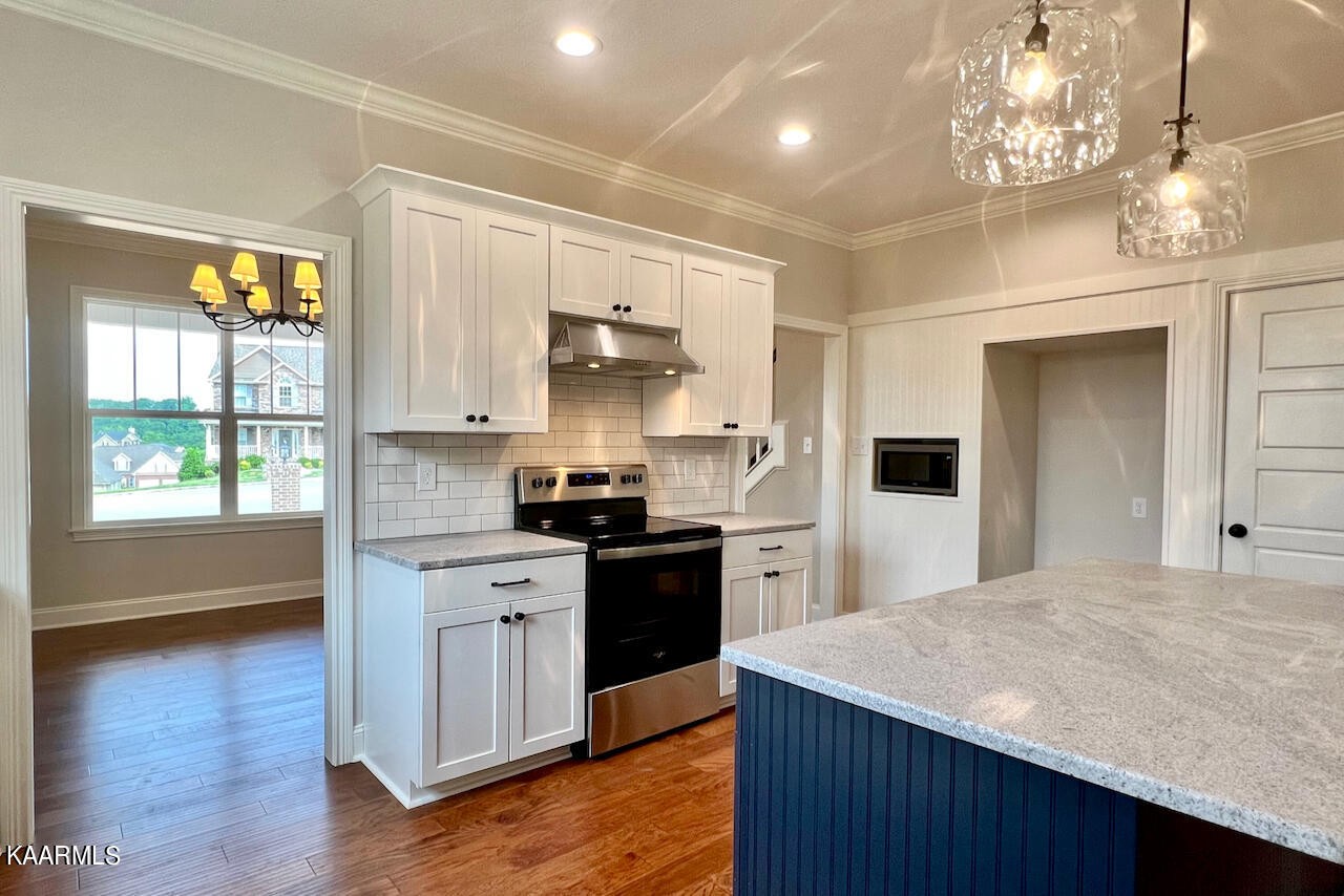 9356 Gabrielle Road Strawberry Plains, TN 37871 - Photo 9 of 39 a kitchen with kitchen island a sink stainless steel appliances and cabinets