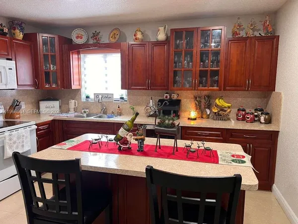 a kitchen with a refrigerator and a stove top oven