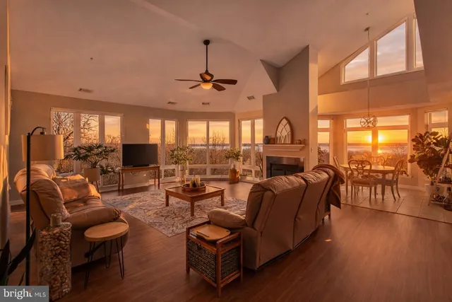 a living room with furniture and floor to ceiling windows