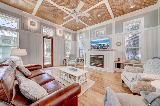 a spacious bedroom with a bed and wooden floor