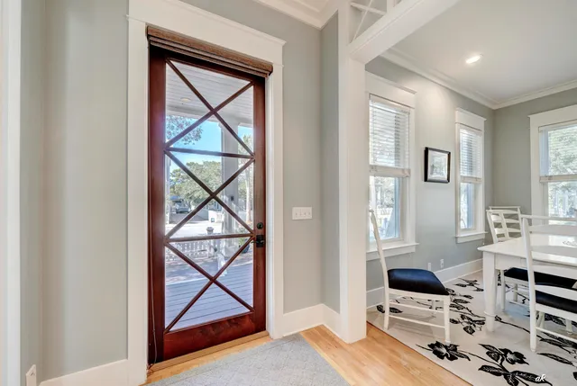 a living room with furniture a fireplace and a large window