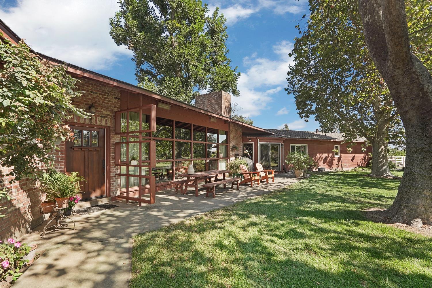 a view of a house with a yard porch and sitting area