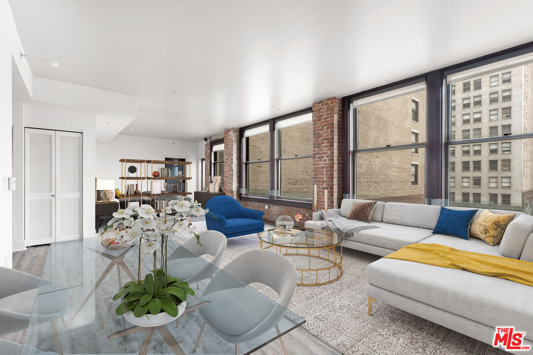 460 South Spring Street, Unit 507 Los Angeles, CA 90013 - Photo 1 of 25 a living room with furniture and floor to ceiling windows