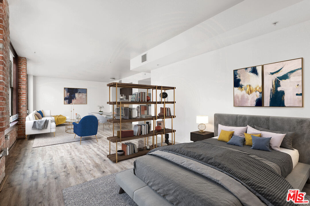 460 South Spring Street, Unit 507 Los Angeles, CA 90013 - Photo 11 of 25 a bedroom with furniture and a book shelf