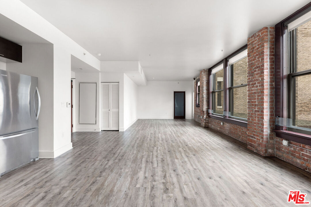 460 South Spring Street, Unit 507 Los Angeles, CA 90013 - Photo 4 of 25 a view of hallway with wooden floor and stairs