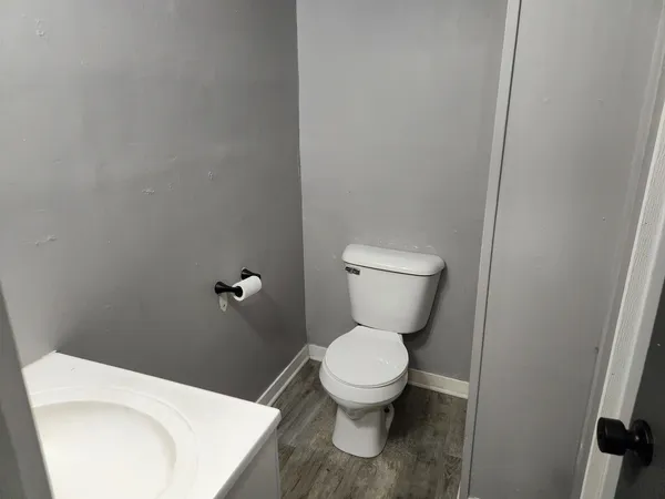 a white toilet sitting next to a white sink