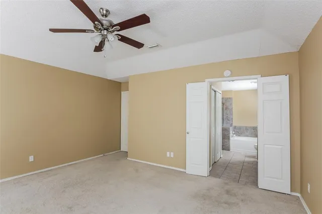 a view of an empty room with a ceiling fan