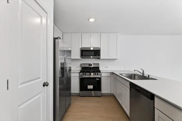 a view of a kitchen with a sink and cabinets