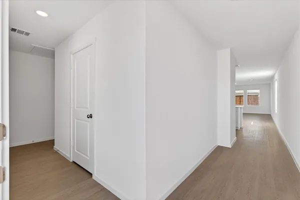 a view of a hallway with wooden floor