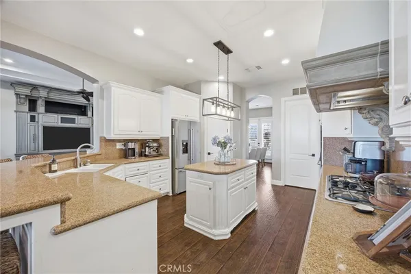 a kitchen with counter top space a sink stainless steel appliances and cabinets
