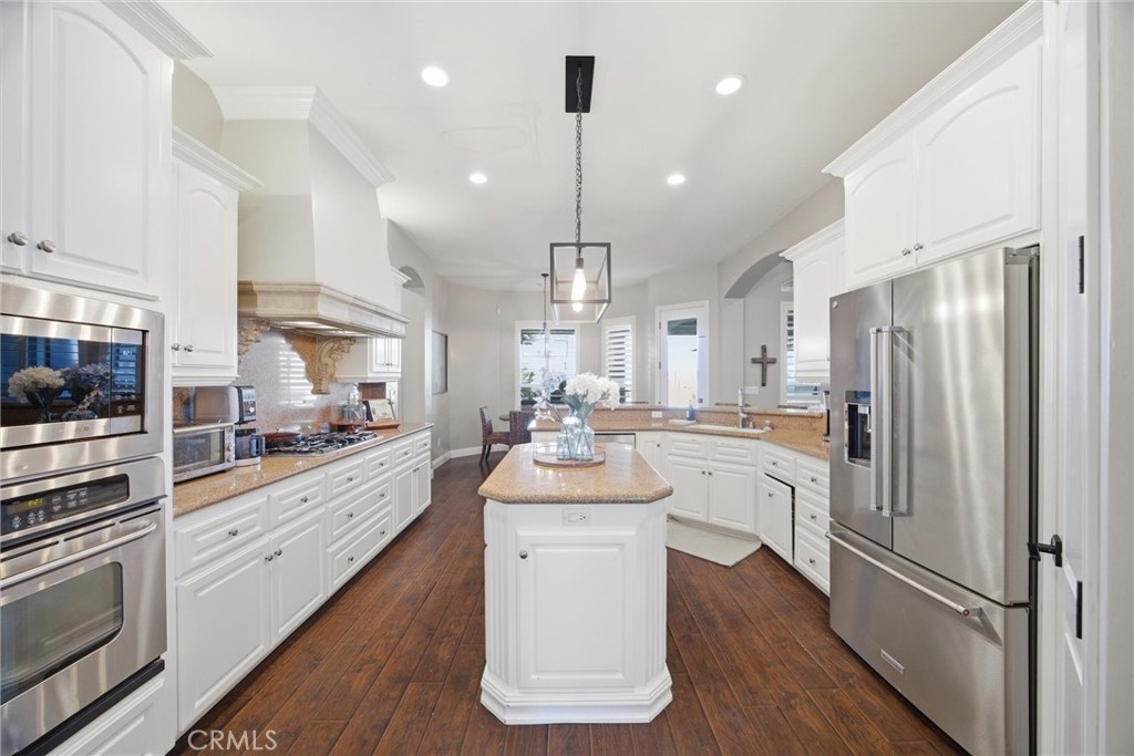 2103 Redmire Street Bakersfield, CA 93311 - Photo 23 of 53 a kitchen with counter top space a sink stainless steel appliances and cabinets
