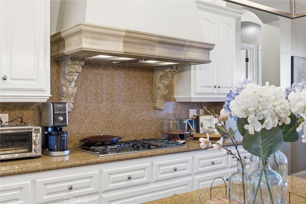 2103 Redmire Street Bakersfield, CA 93311 - Photo 24 of 53 a kitchen with granite countertop a stove a sink and cabinets