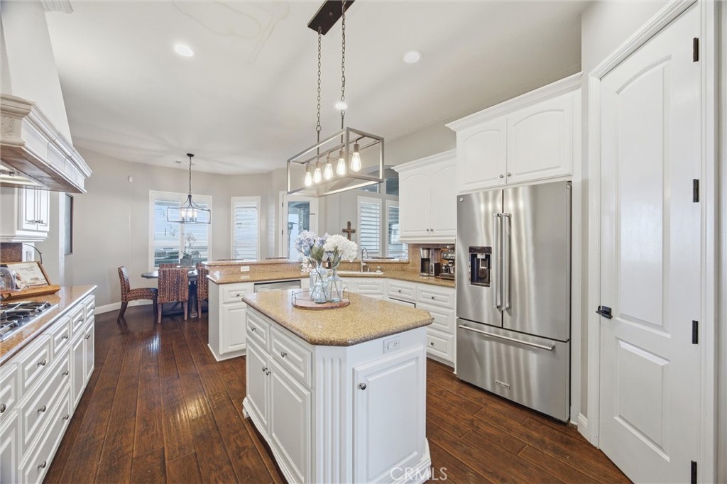 2103 Redmire Street Bakersfield, CA 93311 - Photo 25 of 53 a kitchen with sink refrigerator and cabinets