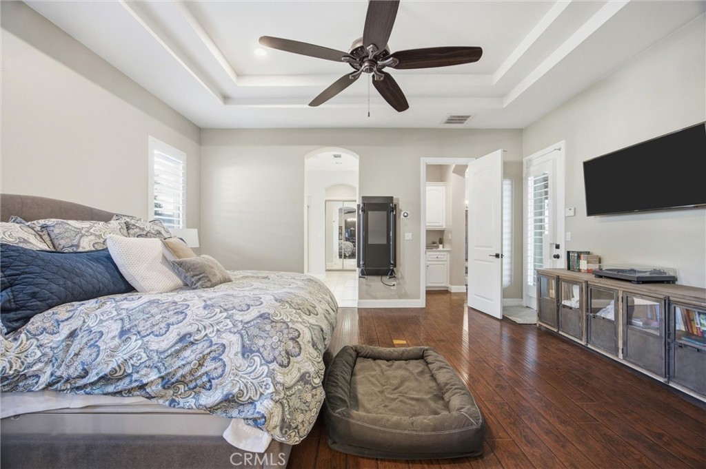 2103 Redmire Street Bakersfield, CA 93311 - Photo 27 of 53 a spacious bedroom with a bed and a flat screen tv