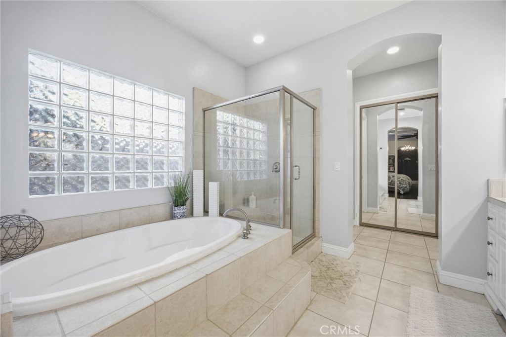 2103 Redmire Street Bakersfield, CA 93311 - Photo 32 of 53 a spacious bathroom with a bathtub and a shower