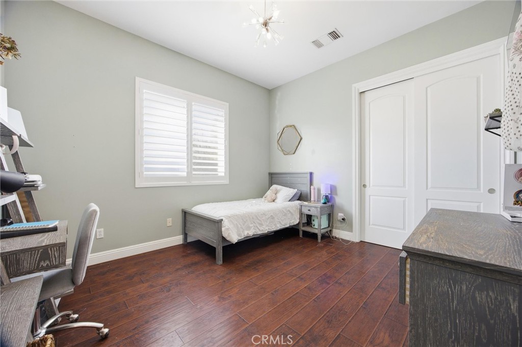 2103 Redmire Street Bakersfield, CA 93311 - Photo 33 of 53 a bedroom with a bed and a table in it