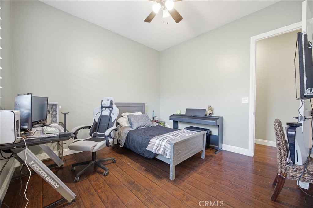 2103 Redmire Street Bakersfield, CA 93311 - Photo 37 of 53 a bedroom with a bed and wooden floor