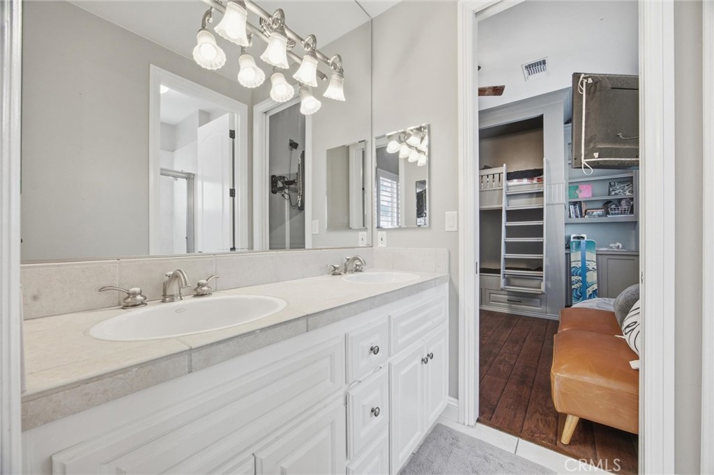 2103 Redmire Street Bakersfield, CA 93311 - Photo 40 of 53 a spacious bathroom with a double vanity sink double vanity and a mirror