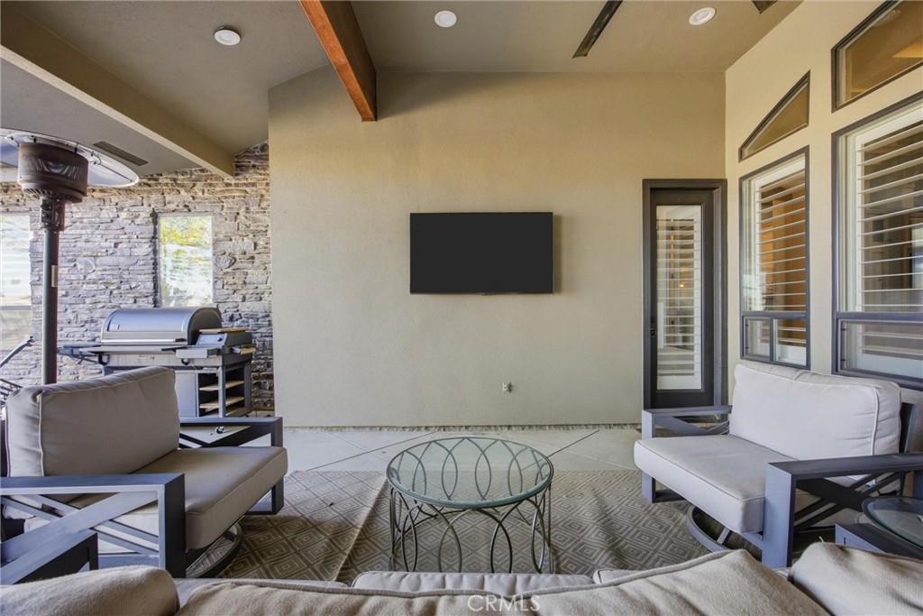 2103 Redmire Street Bakersfield, CA 93311 - Photo 46 of 53 a living room with a couch and a flat screen tv