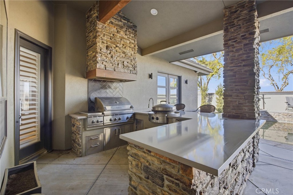 2103 Redmire Street Bakersfield, CA 93311 - Photo 49 of 53 a kitchen with a stove a refrigerator and a dining table