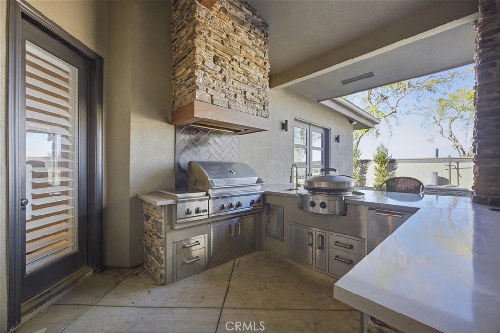 2103 Redmire Street Bakersfield, CA 93311 - Photo 51 of 53 a kitchen with stainless steel appliances granite countertop a stove a sink and a refrigerator