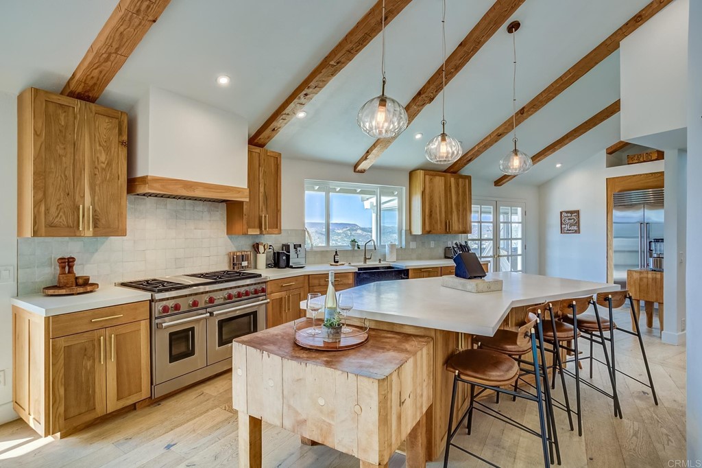 24596 Fuerte Road Temecula, CA 92590 - Photo 11 of 44 a kitchen with sink a stove and chairs