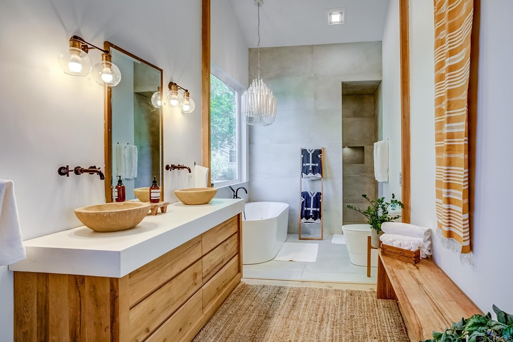 24596 Fuerte Road Temecula, CA 92590 - Photo 15 of 44 a bathroom with a double vanity sink and a mirror